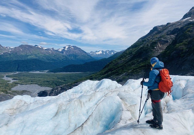Photo of person standing on glacier